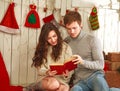 Happy couple in love in holiday home reading book together Royalty Free Stock Photo