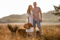 young happy couple in love hugging on nature. Man and woman hugging, sunlight in summer meadow. Happy family in the Royalty Free Stock Photo