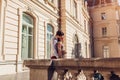 Young happy couple in love hugging outdoors. Romantic man and woman walking by old city architecture Royalty Free Stock Photo