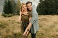 Young happy couple in love hugging smiling and having fun in the mountains Royalty Free Stock Photo