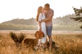 young happy couple in love kissing and hugging on nature. Man and woman hugging, sunlight in summer meadow. Happy Royalty Free Stock Photo