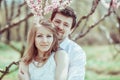 Young happy couple in love outdoors. loving man and woman on a walk at spring blooming park Royalty Free Stock Photo