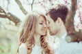 Young happy couple in love outdoors. loving man and woman on a walk at spring blooming park Royalty Free Stock Photo