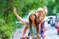 Young happy couple in love riding a retro scooter in the street Royalty Free Stock Photo