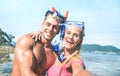 Young happy couple in love taking selfie in tropical excursion with water camera - Boat trip snorkeling in exotic scenarios Royalty Free Stock Photo