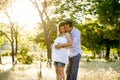 Young happy couple in love together on park landscape sunset with woman pregnant belly Royalty Free Stock Photo