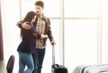 Young happy couple with luggage in hotel room Royalty Free Stock Photo