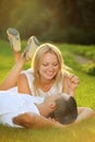 Young happy couple lying down on grass in the sun Royalty Free Stock Photo