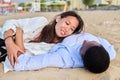 Young happy couple lying on the sand, top view Royalty Free Stock Photo