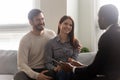 Young happy couple, man and woman negotiating purchase deal.