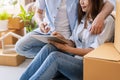 Young happy couple moving in new house, sitting and relaxing on the floor and looking for home decorating ideas Royalty Free Stock Photo
