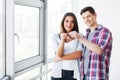 Young happy couple moving into their new home. They unpacking and cleaning new home Royalty Free Stock Photo