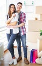 Young happy couple moving into their new home. They unpacking and cleaning new home Royalty Free Stock Photo