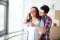 Young happy couple moving into their new home. They unpacking and cleaning new home Royalty Free Stock Photo