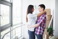 Young happy couple moving into their new home. They unpacking and cleaning new home Royalty Free Stock Photo