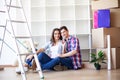 Young happy couple moving into their new home. They unpacking and cleaning new home Royalty Free Stock Photo