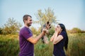 Young happy couple on nature,the boy gives girl a dog - yorkshire terrier as gift