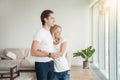 Young happy couple near the window, holding a key Royalty Free Stock Photo