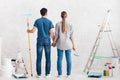 Young happy couple planning to paint their new home interior Royalty Free Stock Photo