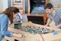 Young happy couple playing table football Royalty Free Stock Photo