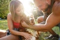 Young happy couple playing with their dog smiling in park Royalty Free Stock Photo