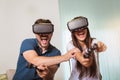 Happy couple playing video games virtual reality glasses. Couple having fun with new trends technology