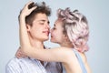 Young happy couple posing in studio.Gorgeous woman with long blond hair posing with handsome brunette man with sportive Royalty Free Stock Photo