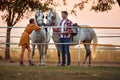 Young couple preparing their horses for a ride on  farm Royalty Free Stock Photo