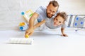 Young happy couple is repairing and painting   wall at home Royalty Free Stock Photo