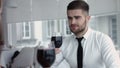 Young happy couple romantic date drink glass of red wine at restaurant, celebrating valentine day Royalty Free Stock Photo