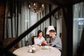 Young happy couple romantic date drink glass of red wine at restaurant, celebrating valentine day Royalty Free Stock Photo