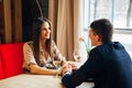 Young happy couple romantic date drink glass of white wine at restaurant, celebrating valentine day Royalty Free Stock Photo