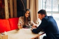 Young happy couple romantic date drink glass of white wine at restaurant, celebrating valentine day Royalty Free Stock Photo