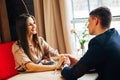 Young happy couple romantic date drink glass of white wine at restaurant, celebrating valentine day Royalty Free Stock Photo