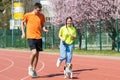 Young happy couple running with a dog Royalty Free Stock Photo