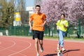 Young happy couple running with a dog Royalty Free Stock Photo