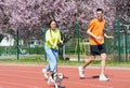 Young happy couple running with a dog Royalty Free Stock Photo