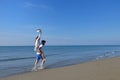 Young happy couple on seashore. Male has beard. Royalty Free Stock Photo