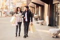 Young happy couple with shopping bags walking outdoors Royalty Free Stock Photo