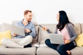 Young happy couple sitting on a couch with laptop Royalty Free Stock Photo