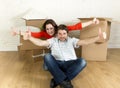 Young happy couple sitting on floor together celebrating moving in new flat house or apartment Royalty Free Stock Photo