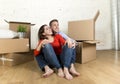 Young happy couple sitting on floor together celebrating moving in new flat house or apartment Royalty Free Stock Photo