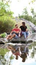 Young happy couple sitting on rock. Camping vacation Royalty Free Stock Photo