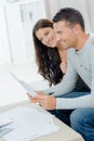 young happy couple sitting on sofa calculating budget Royalty Free Stock Photo