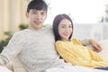 Young happy couple sitting together in the living room Royalty Free Stock Photo