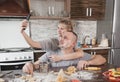 a young happy married couple smeared with flour takes a selfie in the kitchen Royalty Free Stock Photo