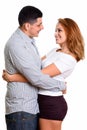 Profile view of young happy Hispanic couple smiling and looking each other Royalty Free Stock Photo