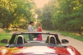 Young happy couple standing near red car Royalty Free Stock Photo