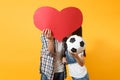 Young happy couple supporter, woman man, football fans cheer up support team, kissing behind red heart love, soccer ball Royalty Free Stock Photo