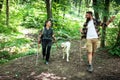 Young happy couple and their dog at hiking through the woods enjoying the sight. Two nature lovers in the mountain forest enjoy Royalty Free Stock Photo